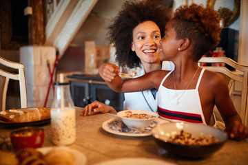 Wall Mural - Mother and daughter breakfast together at Christmas morning