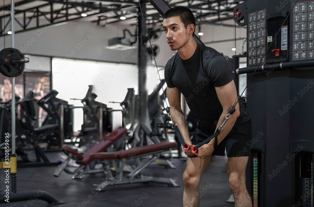 athletic man doing chest exercise using cable crossover machine gym ...