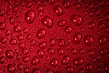 A Close Up Abstract Macro Photo Of Water Droplets On A Grey Non Stick Frying Pan Material Lit With A Red Flash Gel