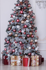 Wall Mural - Beautiful Christmas tree decorated with toys and gift boxes