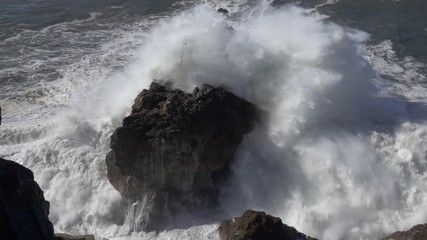 Poster - High waves breaking on the rocks of the coastline, slow motion 4k