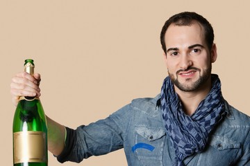 Wall Mural - Portrait of a happy young man with champagne over colored background