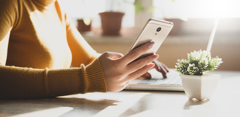 Canvas Print - women hand holding phone on computer background