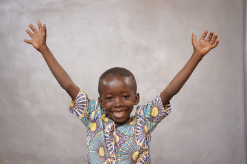 Wall Mural - Laughing Cheerful African black boy is Incredibly Happy with Copy Space