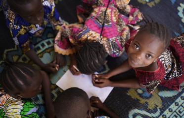 group of african black children working with paper and drawing