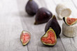 Sweet figs and goat cheese on light wooden board - healthy diet. Selective focus with copy space
