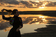 © евгений ставников - blonde girl in denim jacket on the lake.reflection of clouds in water