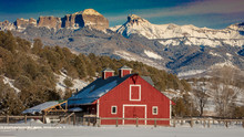 FEB 24, 2019, RIDGWAY, COLORADO USA - Red Barn Under Cimeron Mountains Outside Of Ridgway Colorado On State Route 550