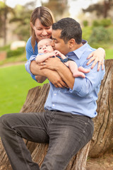 Wall Mural - Happy Mixed Race Family Posing for A Portrait in the Park