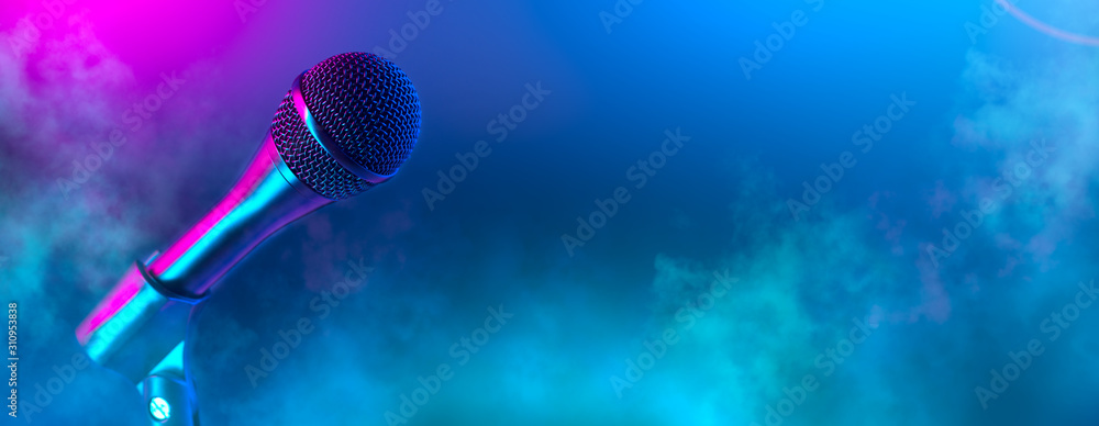 Microphone on stage close-up. Mic closeup. Karaoke, night club, bar. Music concert. Mike over colorful lights background. Song, music concept wide backdrop, border art design - obrazy, fototapety, plakaty 