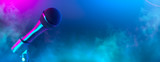Microphone on stage close-up. Mic closeup. Karaoke, night club, bar. Music concert. Mike over colorful lights background. Song, music concept wide backdrop, border art design