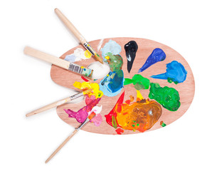 Palette with paints and brushes isolated on a white background.