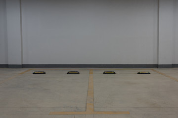 Background of 2 empty underground parking spaces