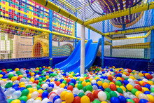 Kids Playground Indoor. Panoramic View Inside The Dry Pool With Colorful Balls And Slide. Nice Plastic Gym For Activity In Playroom.