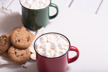 Wall Mural - Red mug with cocoa and marshmallows and homemade cookies with chocolate, wooden heart - Christmas tree toy on a light background