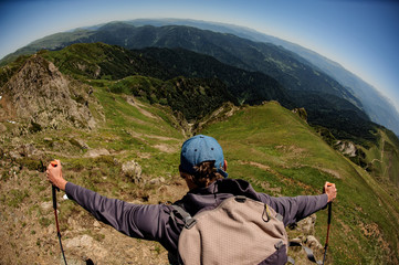 Traveller conquering the mountain top and looking at scenery