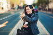 © Etoilestars - Happy beautiful professional business woman outdoors holding disposable paper cup.