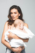 © LIGHTFIELD STUDIOS - portrait of beautiful naked mother holding adorable baby boy, isolated on grey