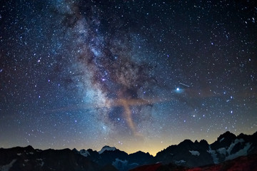 The Milky Way arch starry sky on the Alps, Massif des Ecrins, Briancon Serre Chevalier ski resort, France. Panoramic view high mountain range and glaciers, astro photography, stargazing