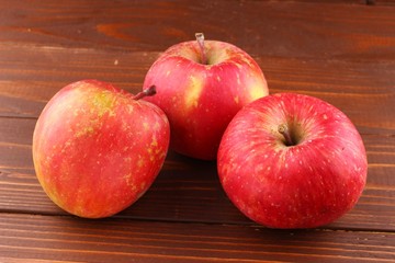 Wall Mural - Red apple Fuji grade on the wooden background