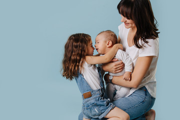 Family photo, children and mom hugging together