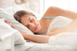 © Sergii - Morning at Home. Woman lying on bed sleeping on side calm close-up