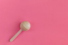 Wooden Baby Rattle On A Pink Background. Flat Lay, Hand Made, Copy Space, Top View, Toy.