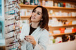© lubero - .Young female pharmacist working in her large pharmacy. Placing medications, taking inventory. Lifestyle