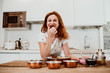 © lubero - Beautiful red haired middle-aged woman cooking healthy food to stay fit and be in good healht. Relaxed and carefree. Lifestyle