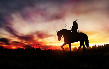 indian of america on horseback at sunset