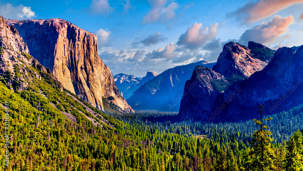 Tunnel View of Yosemite Valley with famous granite rock El Capitan on the left and dry Bridalveil Fall and imposing Cathedral Rocks on the right in Yosemite National Park, California, United States - obrazy, fototapety, plakaty 