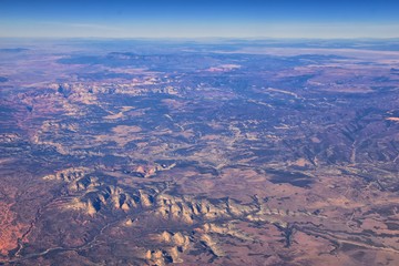 Wall Mural - Colorado Rocky Mountains Aerial view from airplane of abstract Landscapes, peaks, canyons and rural cities in southwest Colorado and Utah. United States of America. USA.
