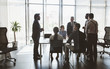 © xartproduction - Silhouettes of people sitting at the table. A team of young businessmen working and communicating together in an office. Corporate businessteam and manager in a meeting