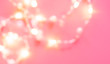 blurred Christmas garlands on pink background