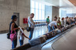 © Kekyalyaynen - Family waiting their suitcase on baggage carousel in airport terminal