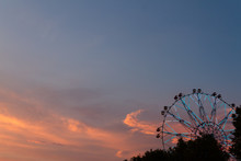 Silhouette Of Ferris Wheel At Sunset At County Fair.