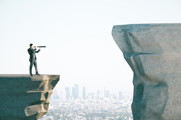 Poster - Young businessman on cliff looking into distance