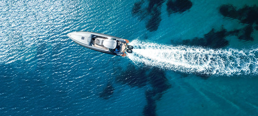 Wall Mural - Aerial drone ultra wide panoramic photo of high speed inflatable rib boat cruising in high speed in tropical exotic bay