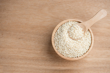 Wall Mural - close up of white sesame seed on wooden bowl in kitchen.