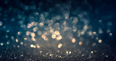 Wall Mural - blue abstract glitter bokeh on black background