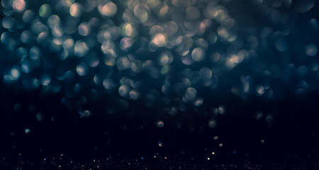 Wall Mural - blue abstract glitter bokeh on black background