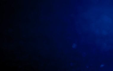 Wall Mural - blue abstract glitter bokeh on black background