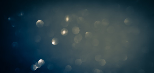 Wall Mural - blue abstract glitter bokeh on black background