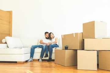 Wall Mural - young couple moves to a new home. the family carries boxes of things after buying a home.