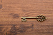 © Corgarashu - Old vintage key on a wooden background.