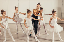 Little Girls Practice In Ballet Class With Young Female Teacher, Wearing Special Tutu Suits, Performing Ballet Dance