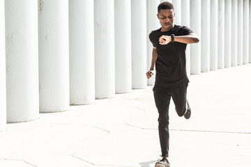 Sticker - Athletic young afroamerican man running on the promenade. Black Male runner sprinting outdoors. Healthy lifestyle concept.