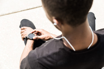 Sticker - Athletic young afroamerican runner doing warm up on the promenade. Black Male running on outdoors. Healthy lifestyle concept.