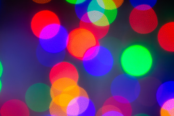 abstract, unfocused image with colorful bright bubbles in the black background. modern pattern for d