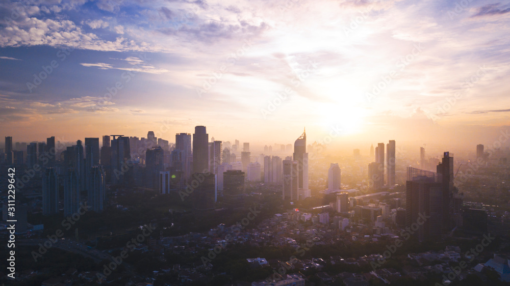 Reddish white sunrise or sunset in Jakarta city - obrazy, fototapety, plakaty 